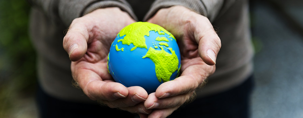 Person holding world for donations